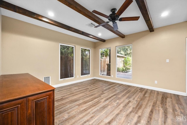 interior space featuring beam ceiling, ceiling fan, and light wood-type flooring