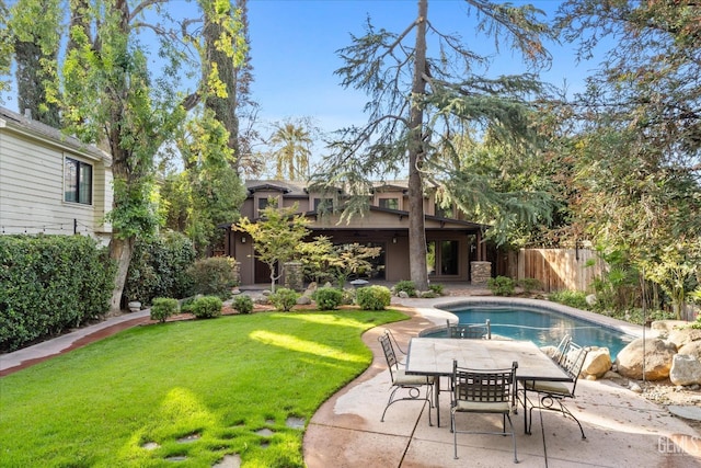 view of swimming pool with a lawn and a patio