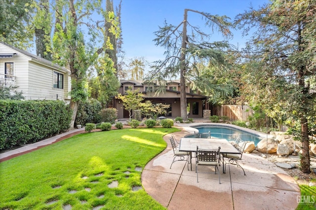 view of swimming pool with a lawn and a patio area