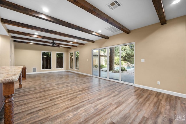 unfurnished living room with beam ceiling, ceiling fan, and light hardwood / wood-style flooring