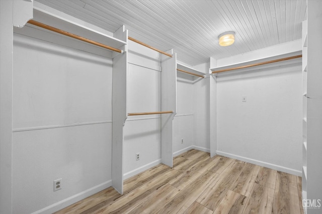 walk in closet with light wood-type flooring