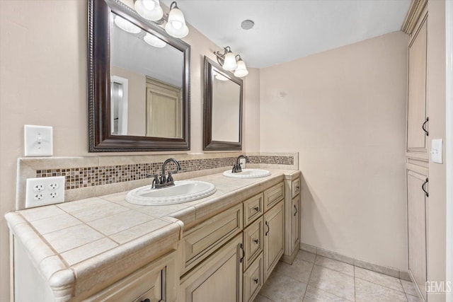 bathroom featuring tile patterned floors, vanity, and backsplash