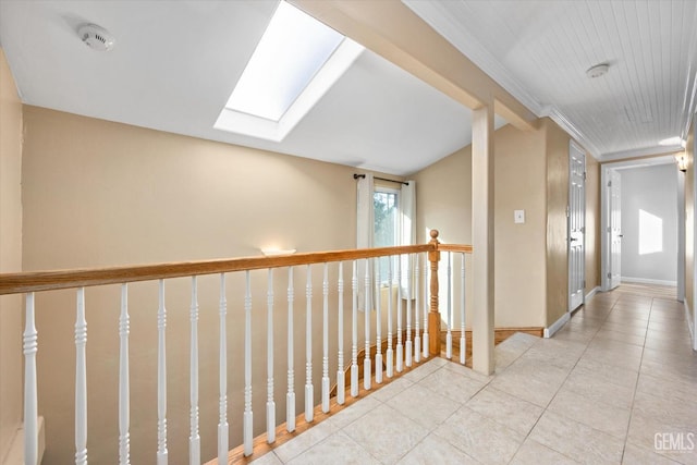 hall featuring a skylight and light tile patterned flooring