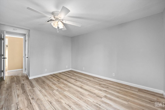 spare room featuring light hardwood / wood-style floors and ceiling fan