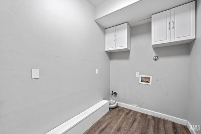 washroom featuring dark hardwood / wood-style flooring, hookup for a washing machine, and cabinets