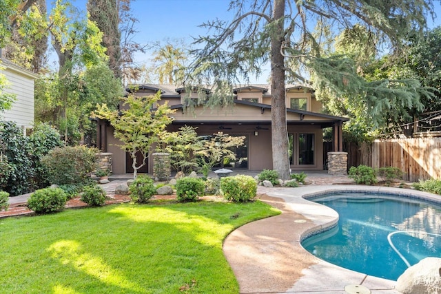 view of swimming pool with a yard and a patio