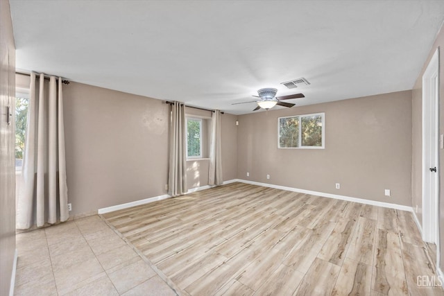 empty room with ceiling fan and light wood-type flooring