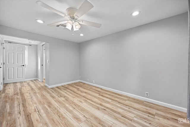 empty room featuring ceiling fan and light wood-type flooring