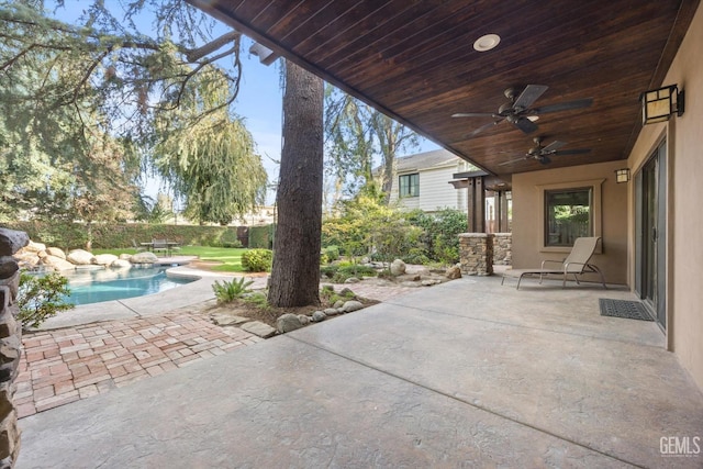 view of patio featuring a fenced in pool and ceiling fan