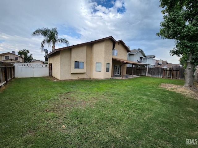 5913 El Camino Ave, Bakersfield, CA 93313 - back of property with stucco siding and a patio