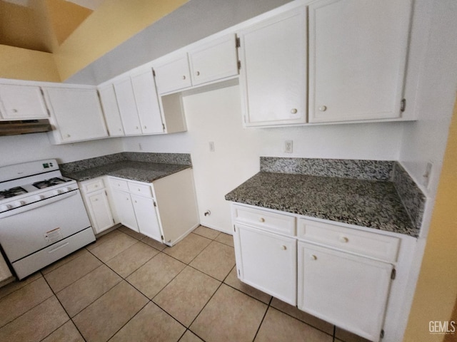 5913 El Camino Ave, Bakersfield, CA 93313 - kitchen featuring gas range gas stove, white cabinets, dark countertops, light tile patterned floors, and under cabinet range hood
