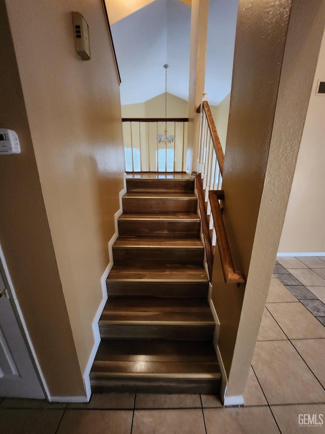 5913 El Camino Ave, Bakersfield, CA 93313 - stairway featuring tile patterned floors, vaulted ceiling, a chandelier, and baseboards