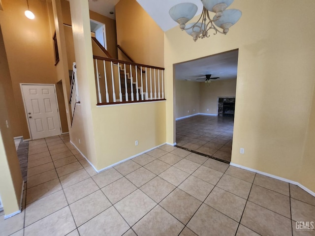 5913 El Camino Ave, Bakersfield, CA 93313 - entrance foyer with light tile patterned floors, a chandelier, stairway, a towering ceiling, and baseboards