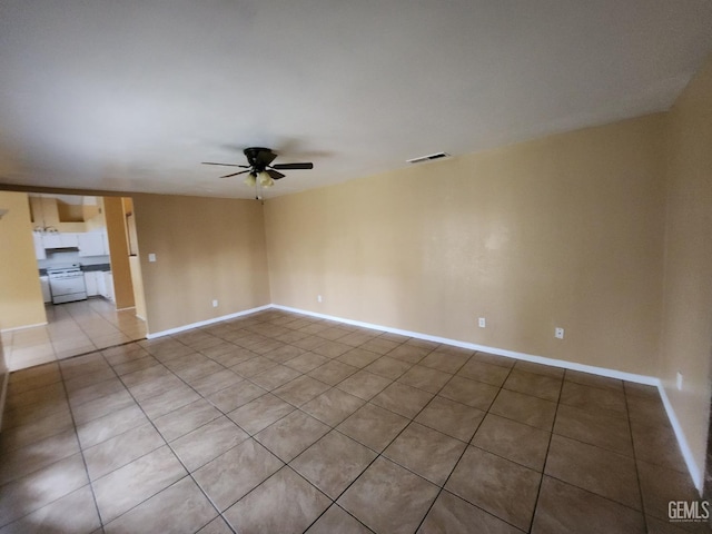 5913 El Camino Ave, Bakersfield, CA 93313 - unfurnished room featuring ceiling fan, light tile patterned floors, and baseboards