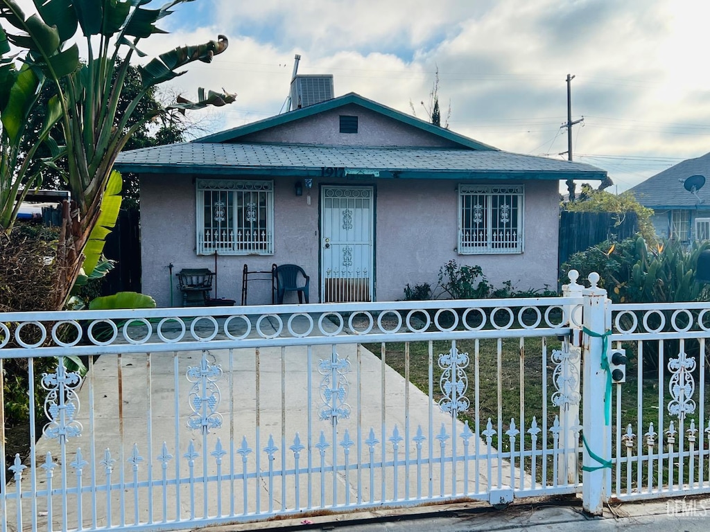 bungalow-style home with central air condition unit