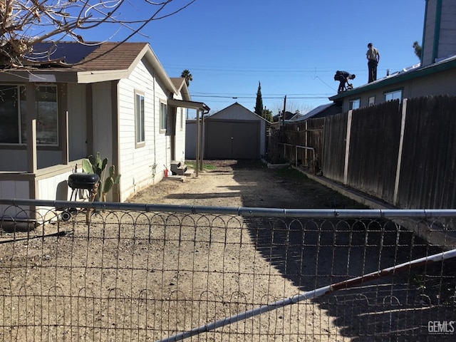 view of side of property featuring a storage unit