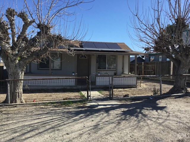 view of front of house featuring solar panels and a porch