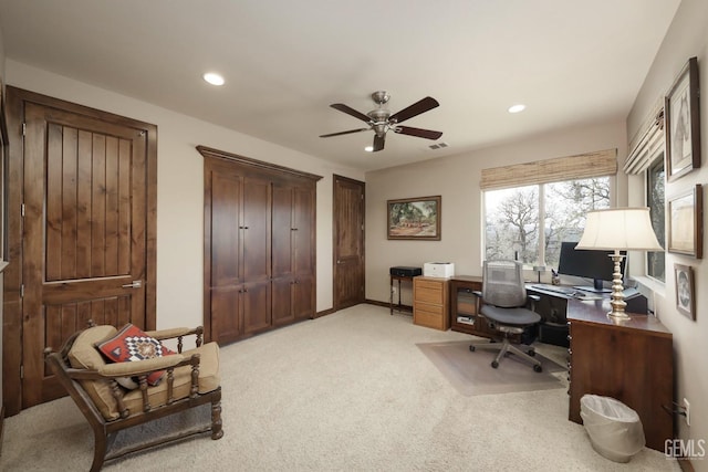 office space featuring recessed lighting, a ceiling fan, visible vents, and light carpet