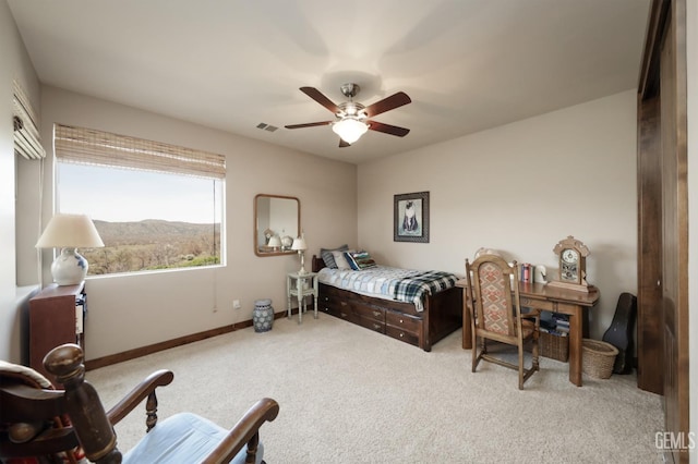 carpeted bedroom featuring visible vents, a ceiling fan, and baseboards