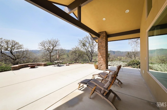 view of patio / terrace featuring a mountain view