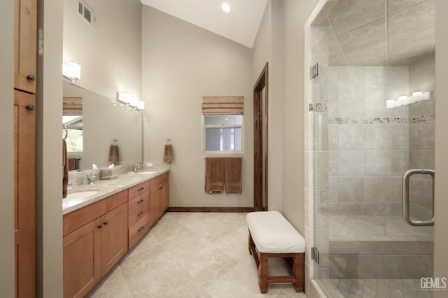 bathroom with double vanity, visible vents, a stall shower, a sink, and lofted ceiling