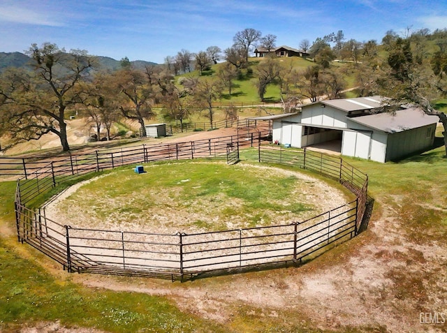 view of yard with an outdoor structure, an exterior structure, and a rural view