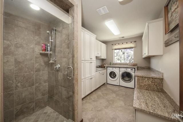 laundry area featuring visible vents, laundry area, and washer and clothes dryer