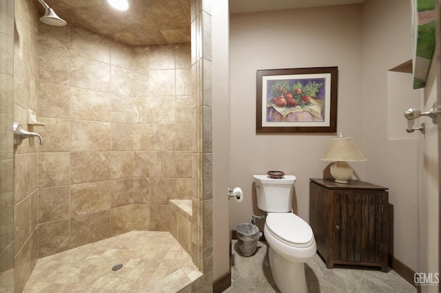 bathroom with toilet and tiled shower