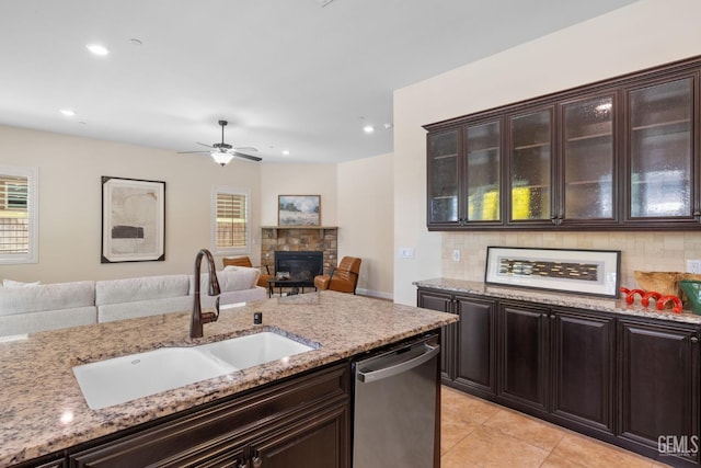 14822 Plumeria Ct, Bakersfield, CA 93314 - kitchen with a sink, stainless steel dishwasher, open floor plan, backsplash, and plenty of natural light