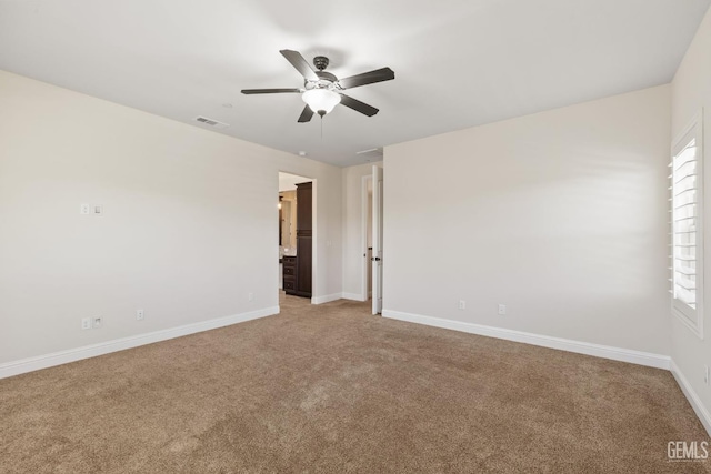 14822 Plumeria Ct, Bakersfield, CA 93314 - spare room featuring light carpet, a ceiling fan, and baseboards