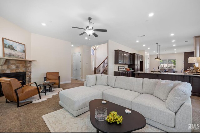 14822 Plumeria Ct, Bakersfield, CA 93314 - living area with a ceiling fan, a stone fireplace, recessed lighting, stairs, and light carpet