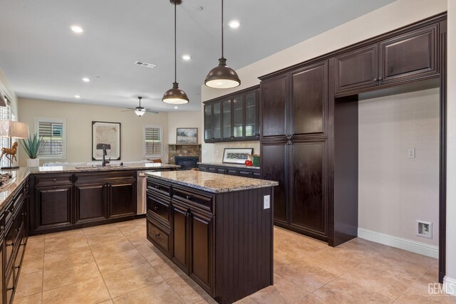 14822 Plumeria Ct, Bakersfield, CA 93314 - kitchen featuring a sink, a ceiling fan, a peninsula, light stone counters, and recessed lighting