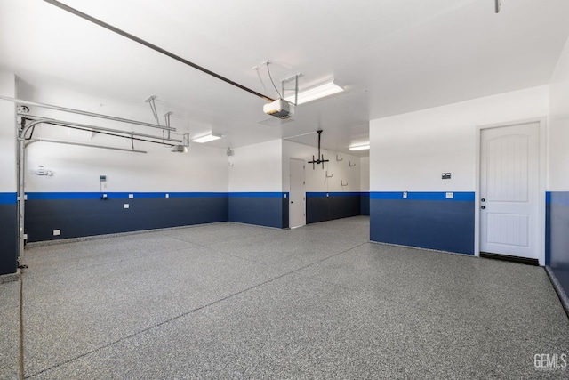 14822 Plumeria Ct, Bakersfield, CA 93314 - garage featuring a garage door opener and baseboards