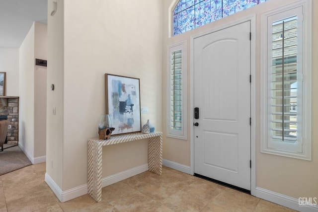 14822 Plumeria Ct, Bakersfield, CA 93314 - entryway with healthy amount of natural light, baseboards, and light tile patterned floors