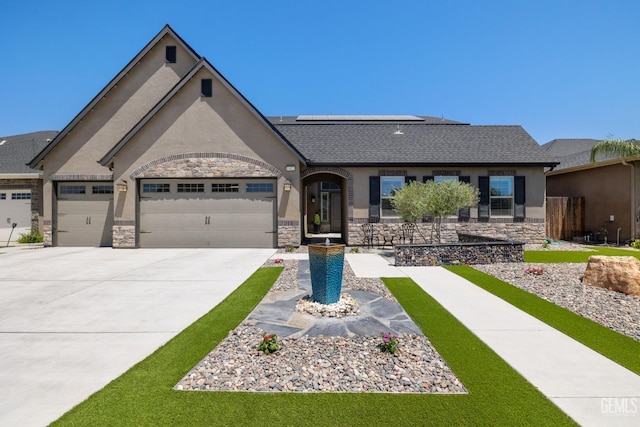 14822 Plumeria Ct, Bakersfield, CA 93314 - view of front of property with stone siding, stucco siding, concrete driveway, an attached garage, and solar panels