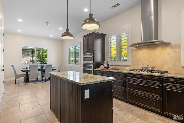 14822 Plumeria Ct, Bakersfield, CA 93314 - kitchen with wall chimney range hood, appliances with stainless steel finishes, light tile patterned flooring, tasteful backsplash, and recessed lighting