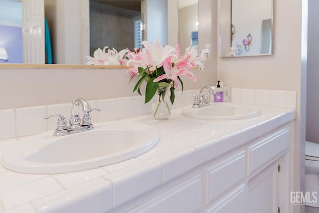 7116 Jolynn St, Bakersfield, CA 93308 - bathroom featuring double vanity and toilet