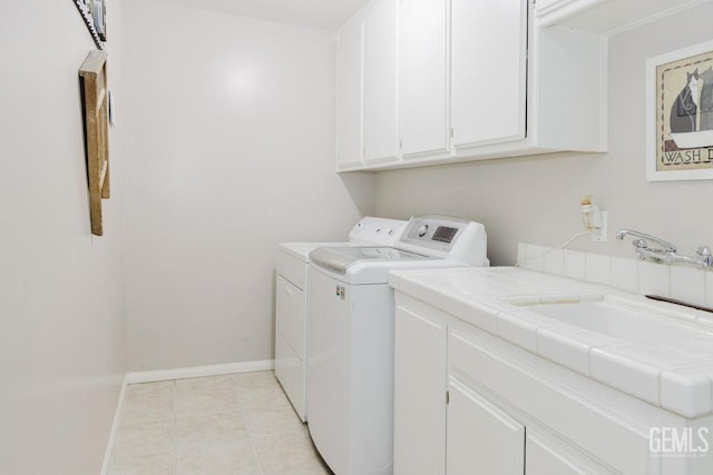 7116 Jolynn St, Bakersfield, CA 93308 - laundry area featuring independent washer and dryer, cabinet space, baseboards, and light tile patterned floors
