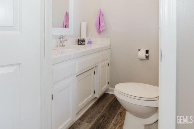 7116 Jolynn St, Bakersfield, CA 93308 - bathroom with vanity, toilet, and wood finished floors