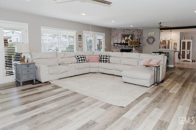 7116 Jolynn St, Bakersfield, CA 93308 - living room with ceiling fan, light wood finished floors, healthy amount of natural light, recessed lighting, and a fireplace