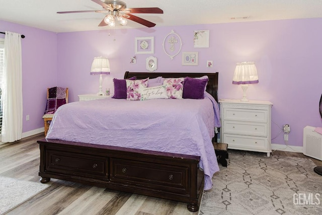 7116 Jolynn St, Bakersfield, CA 93308 - bedroom with baseboards, wood finished floors, radiator, and a ceiling fan
