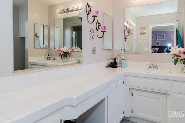 7116 Jolynn St, Bakersfield, CA 93308 - bathroom featuring double vanity and ensuite bathroom