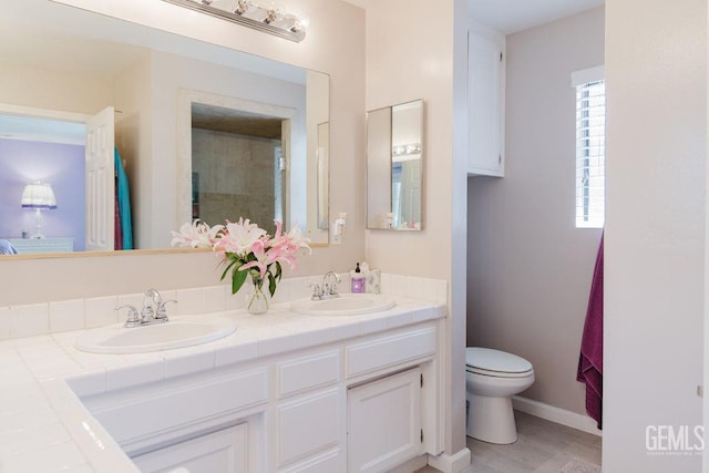 7116 Jolynn St, Bakersfield, CA 93308 - full bath featuring toilet, double vanity, and baseboards