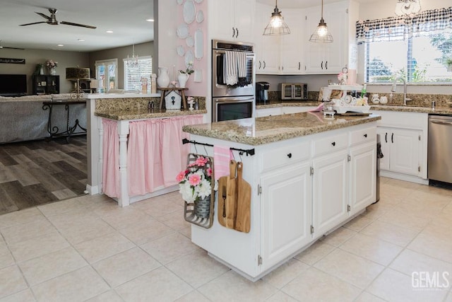 7116 Jolynn St, Bakersfield, CA 93308 - kitchen featuring stainless steel appliances, a sink, healthy amount of natural light, ceiling fan, and recessed lighting
