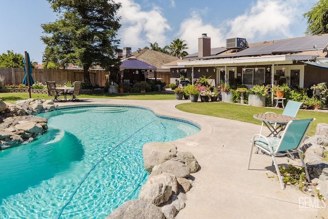 7116 Jolynn St, Bakersfield, CA 93308 - view of swimming pool featuring a fenced backyard, a patio, and central AC unit