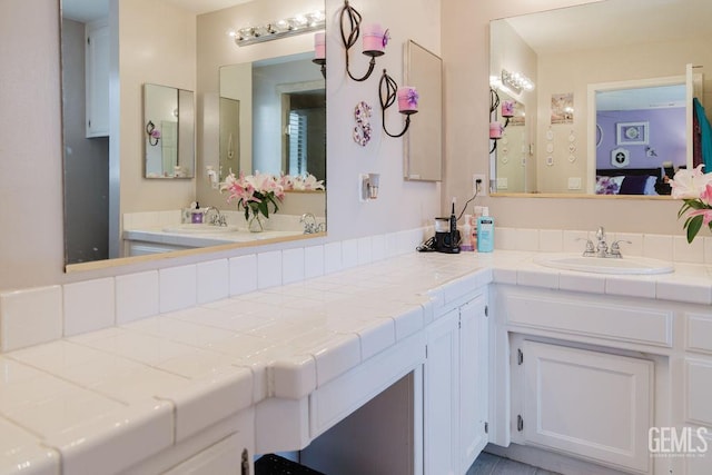 7116 Jolynn St, Bakersfield, CA 93308 - bathroom featuring double vanity and ensuite bath