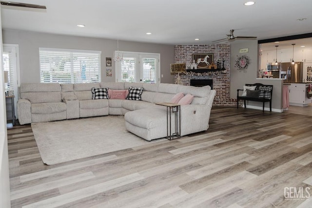 7116 Jolynn St, Bakersfield, CA 93308 - living room with a ceiling fan, light wood-style flooring, recessed lighting, and a fireplace