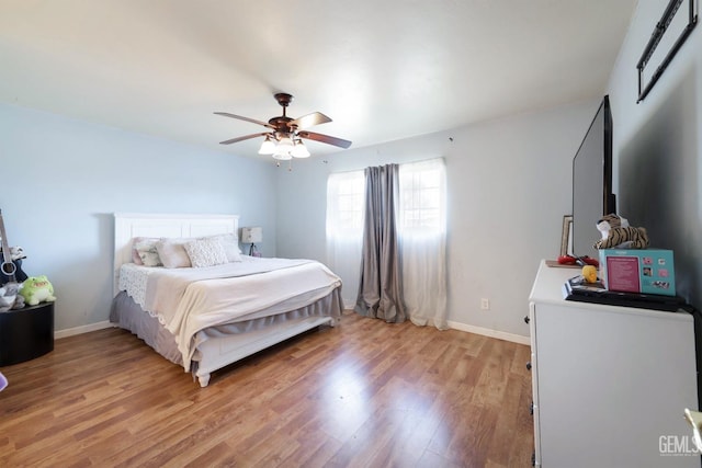 bedroom with ceiling fan and light hardwood / wood-style floors