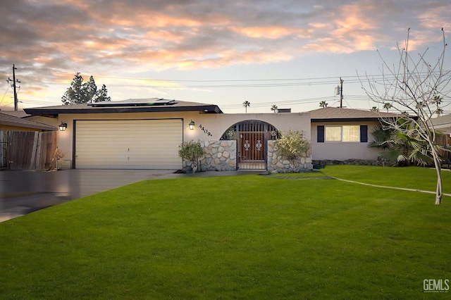 view of front of property with solar panels, a garage, and a yard