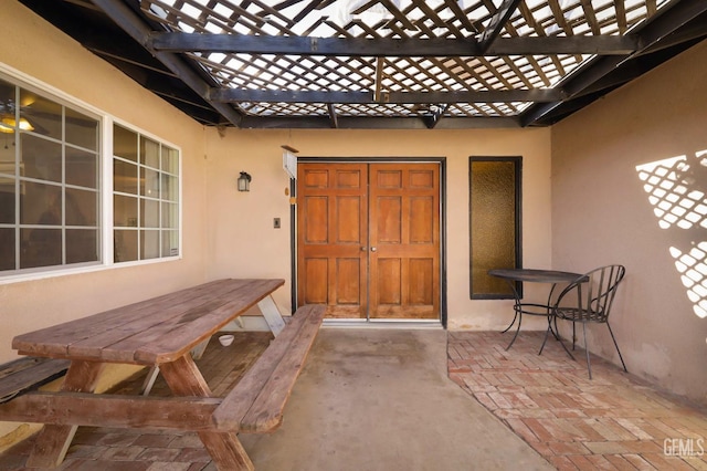 doorway to property with a patio and a pergola